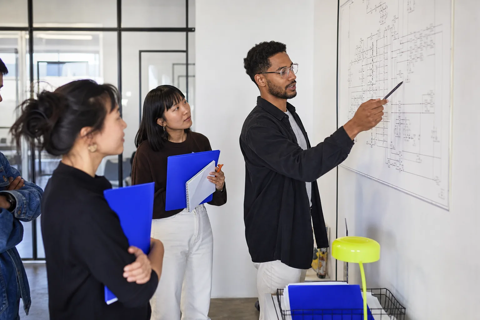 Engineering team collaborating in a bright studio workspace.