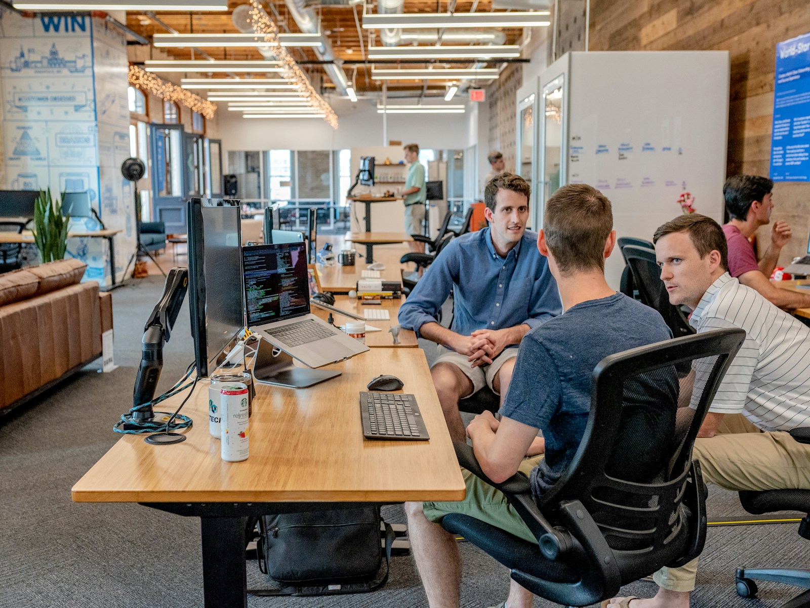Team members reviewing work together in an office.